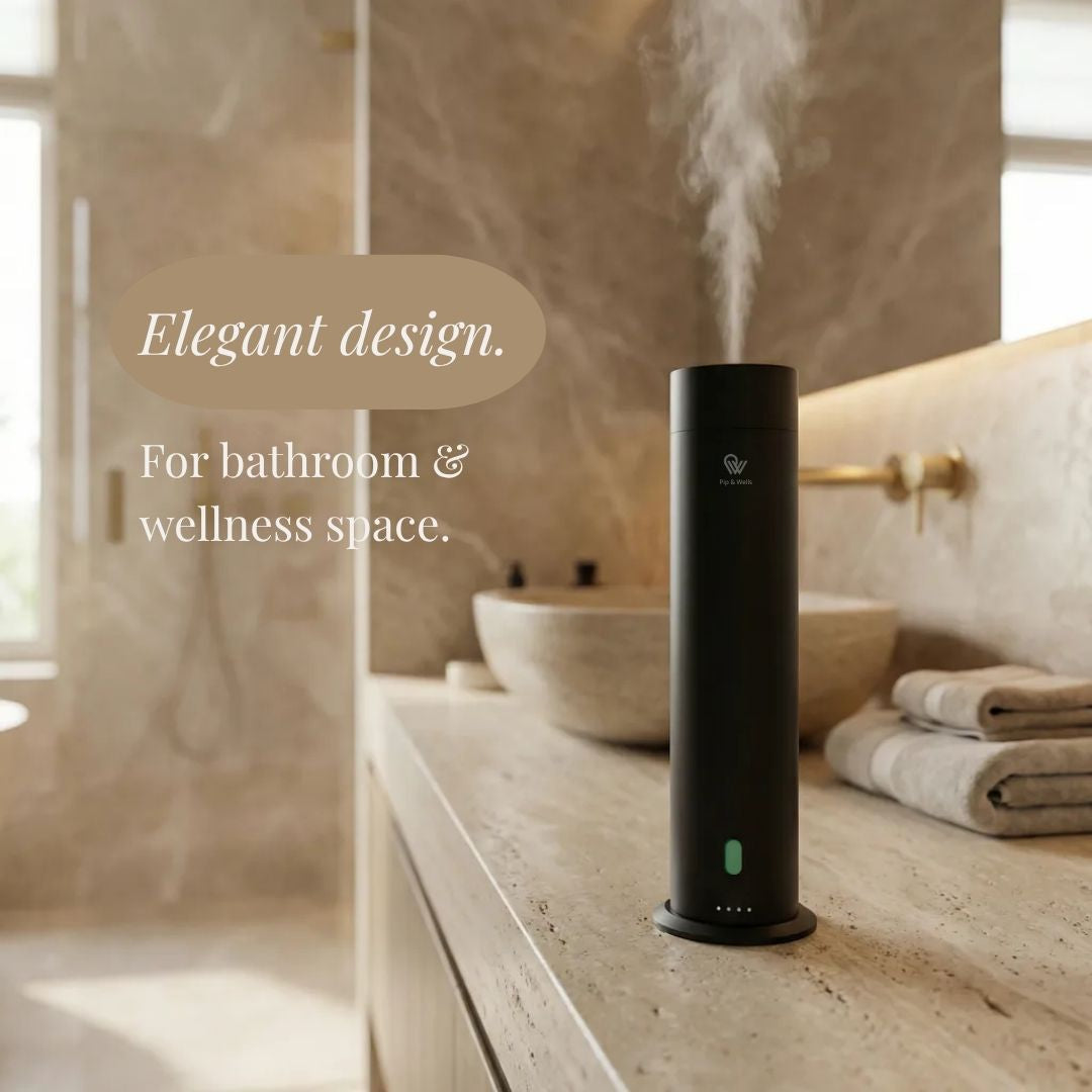 Black humidifier on a bathroom counter with steam rising, text 'Elegant design. For bathroom & wellness space.'