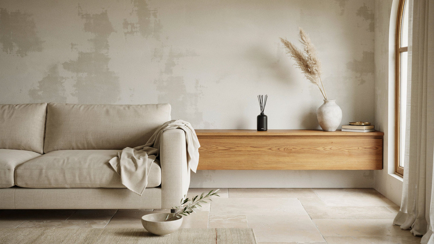 Refined living room with natural textures and home-fragrance styling.