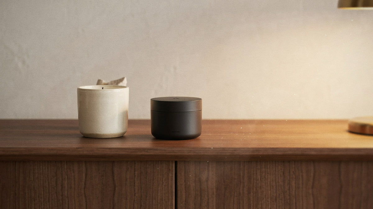 Waterless scent machine beside an ivory scented candle